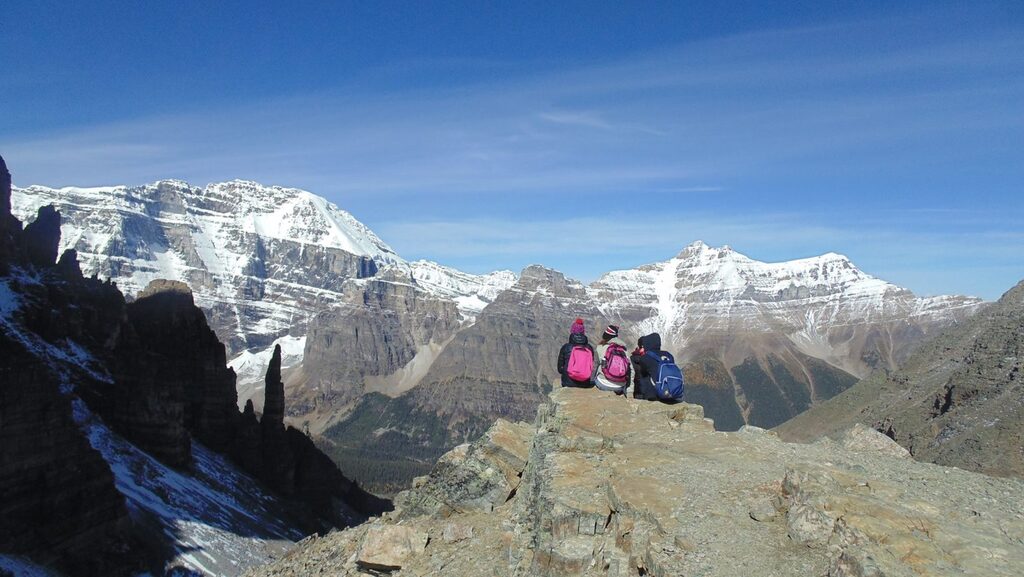 friends sitting overlooking Monument Valley, near Lake Louise